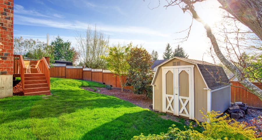 Fenced backyard with storage shed in Florence